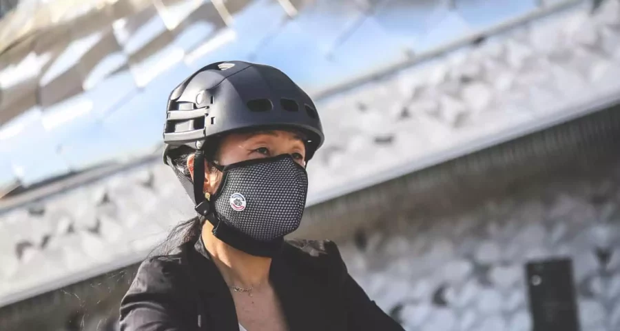 Cycliste avec casque et masque antipollution